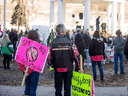 People protest against mandatory mask laws in Saskatoon on March 20, 2021.