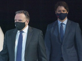 Quebec Premier Francois Legault and Prime Minister Justin Trudeau arrive at a news conference in Montreal, on Monday, March 15, 2021.