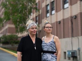 Esther Hladkowicz stands with her daughter Emily outside the long-term care home where her father lives, after their first visit in eight months because of COVID-19 restrictions, in Ottawa, on Saturday, May 22, 2021.