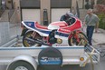 David Booth beguns unloading his Honda motorcycle from Charles Snell's trailer