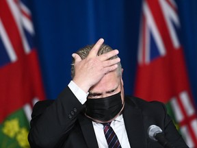 Ontario Premier Doug Ford speaks with the media about plans to end COVID lockdowns and open the province up, at Queen's Park in Toronto on May 20, 2021.
