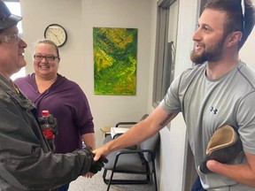 Parker Hansen thanks staff at Millennium Recycling for returning his prosthetic arm.