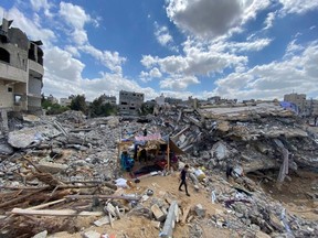A Palestinian boy from Zawaraa family walks near their makeshift tent amid the rubble of their houses which were destroyed by Israeli air strikes during the Israeli-Palestinian fighting in Gaza May 23, 2021.