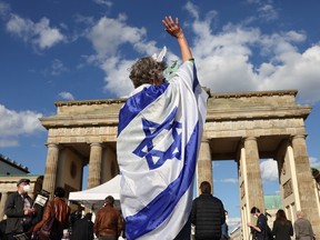 A person gestures ahead of a rally in solidarity with Israel and against antisemitism, in front of the Brandenburg Gate in Berlin, Germany, May 20, 2021.