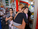 Israelis take cover in a shop  in the country's mediterranean city of Bat Yam, south of Tel Aviv, as a siren rings during an attack of rockets from the Hamas-controlled Gaza Strip, on May 13, 2021.