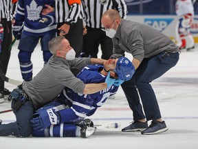 Maple Leafs captain John Tavares is tended to be medical staff after being injured against the Montreal Canadiens in Game 1 at Scotiabank Arena in Toronto on May 20, 2021 in Toronto.