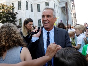 Attorney Robert F. Kennedy Jr. is surrounded by supporters as he departs New York State Supreme Court after a hearing challenging the constitutionality of the NY State Legislature's repeal of the religious exemption to vaccination in Albany, New York, U.S., August 14, 2019.
