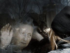 Toronto Sun photographer Veronica Henri was nominated in the general news photo category for this image of a long-term care facility resident and her daughter during the first wave of COVID-19.