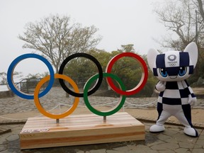 Tokyo 2020 Olympic Games mascot Miraitowa poses with a display of the Olympic symbol after an unveiling ceremony of the symbol on Mt. Takao in Hachioji, west of Tokyo, Japan, April 14, 2021.