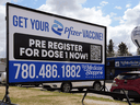 A sign outside a pharmacy in Edmonton on Wednesday May 5, 2021 advises people that the Pfizer vaccine for COVID-19 is available at their location.