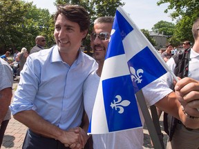 Prime Minister Justin Trudeau poses for photos during Fete Nationale festivities on June 24, 2016, in Ste. Therese, Que.