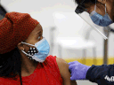 A woman is bandaged after being inoculated against COVID-19 at a vaccination clinic at Downsview Arena in Toronto on April 21, 2021.