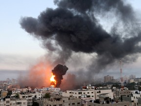 Smoke and flames rise during Israeli air strikes amid a flare-up of Israeli-Palestinian violence, in Gaza May 12, 2021.
