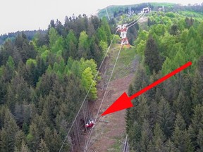A photo capture from an aerial video shows a cable car that crashed to the ground a few hundred meters below its arrival point at Mottarone peak above the resort town of Stresa on the shores of Lake Maggiore.
