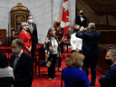 Senators take a photo as they arrive for the opening session in the Senate chamber in Ottawa on Sept. 23, 2020.