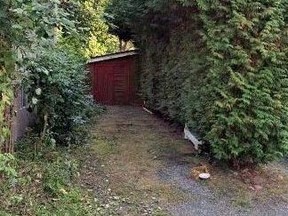 The property at 1912 William St. in Vancouver. The greenery at left has now been trimmed away, exposing the wall of the house next door.