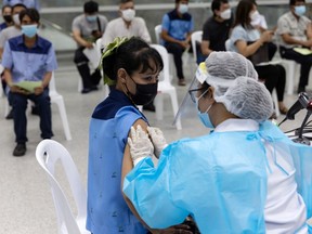 A person receives a dose of the Sinovac Covid-19 vaccine at a vaccination center set up at the Bang Sue Grand Station rail hub in Bangkok, Thailand, on Wednesday, May 26, 2021.