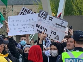 Signs shown at a Saturday rally in support of Palestine.