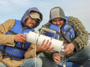 Dallas Goodfellow and Chris Wemigwans collecting water samples during the internship training.