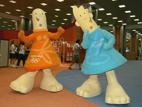 The Official Mascots of the Athens 2004 Olympic Summer Games Athena (L) and Phevos (R) walk through the lobby of the Main Press Center (MPC) prior to the start of games August 10, 2004 in Athens, Greece. The games kickoff with the Opening Ceremonies on August 13.