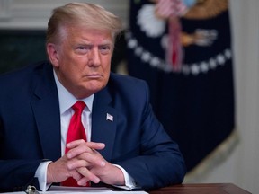 In this file photo taken on November 26, 2020, U.S. President Donald Trump participates in a Thanksgiving teleconference with members of the United States Military, at the White House in Washington, DC.