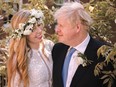 British Prime Minister Boris Johnson, right, poses with his wife Carrie Johnson in the garden of 10 Downing St., following their wedding at Westminster Cathedral, in London, on May 29.