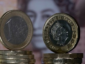 In this file photo taken on December 14, 2017 British one pound sterling coins and Euro coins are arranged in front of a British ten pound sterling note for a photograph in London. - Sterling soared Thursday, October 17, 2019 within a whisker of $1.3, striking five-month peaks after the European Union reached a draft Brexit withdrawal deal with London.