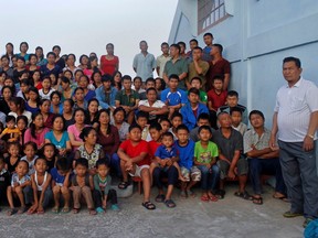 Family members of Ziona (right) poses for group photograph outside their residence in Baktawng village in the northeastern Indian state of Mizoram, on October 7, 2011.