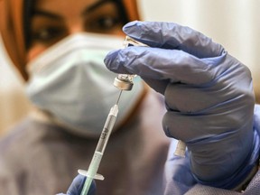 An employee of the United Nations Relief and Works Agency for Palestine Refugees (UNRWA) prepares a shot of the Sputnik V COVID-19 vaccine for medical staff at UNRWA's al-Sheikh Redwan clinic in Gaza City, on February 25, 2021.