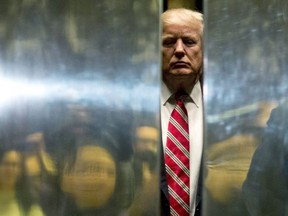 In this file photo taken on January 16, 2017, U.S. President-elect Donald Trump boards the elevator after escorting Martin Luther King III to the lobby after meetings at Trump Tower in New York City.