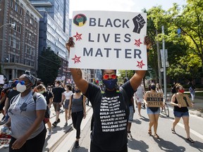 Demonstrators take part in a Black Lives Matter march in downtown Toronto on June 6, 2020, 12 days after George Floyd's murder by a police officer in Minneapolis.