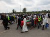 People transport a flag-wrapped coffin, outside the Islamic Centre of Southwest Ontario, during a funeral of the Afzaal family.