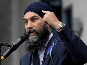 NDP Leader Jagmeet Singh points to his turban as he speaks about racism during a speech at a vigil outside the London Muslim Mosque that was organized after four members of a Muslim-Canadian family were killed in what police describe as a hate-motivated attack, in London, Ont., on June 8.