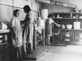 Girls circa 1940 work in the kitchen at the Bishop Horden Memorial School, a residential school in the indigenous Cree community of Moose Factory, Ontario.