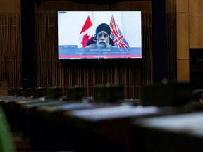 Canada's Minister of National Defence Harjit Sajjan is seen on a screen as he  speaks during Question Period in the House of Commons on Parliament Hill in Ottawa, Ontario, Canada June 22, 2021.