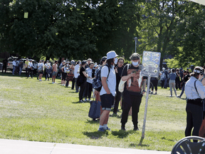 People line up outside a Toronto recreation centre to get a COVID-19 vaccine shot, June 17, 2021.