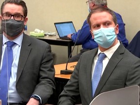 Former Minneapolis police officer Derek Chauvin sits with his defense attorney Eric Nelson as the jury verdict is read, finding him guilty of all charges in his trial for second-degree murder, third-degree murder and second-degree manslaughter in the death of George Floyd in Minneapolis, Minnesota, U.S. April 20, 2021 in a still image from video.