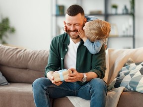 happy family little son congratulates handsome dad for father's day!