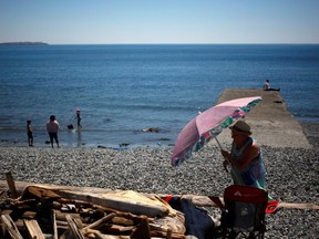 People look for ways to cool off during the 'heat dome,' currently hovering over British Columbia and Alberta as record-setting breaking temperatures scorch the province and in Victoria, British Columbia, Canada June 28, 2021.