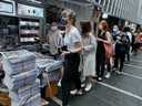 People queue up for last issue of Apple Daily at a newspaper booth at a downtown street in Hong Kong, June 24, 2021. The forced closure comes just eight months after the Communist Party of China leadership imposed a new national security law on Hong Kong.