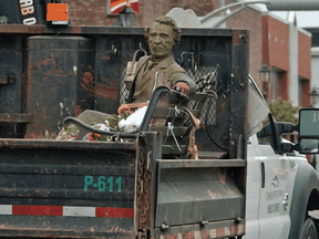A Sir John A. MacDonald statue is trucked away after city crews removed it in Charlottetown, on Tuesday, June 1, 2021.