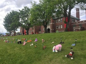 Tributes are left at the former Kamloops Indian Residential School on May 31, 2021, in memory of the 215 children whose remains were found in undocumented graves on the site.
