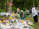 People visit a makeshift memorial at the scene where a man driving a pickup truck ran over a Muslim family in what police say was a deliberately targeted anti-Muslim hate crime, in London, Ontario, June 9, 2021.