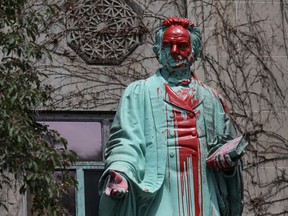 Red paint covers the defaced Ryerson University statue of Egerton Ryerson on  June 2, 2021, following the discovery of the remains of 215 children on the site of British Columbia's former Kamloops Indian Residential School.