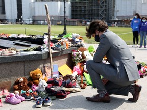 Prime Minister Justin Trudeau visits a makeshift memorial on Parliament Hill erected in honour of the 215 Indigenous children whose remains were found in unmarked graves on the grounds of the Kamloops Residential School in British Columbia, on June 1, 2021.