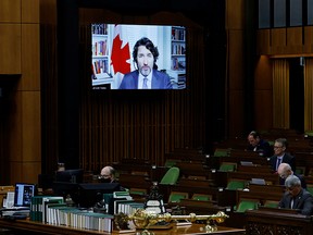 Prime Minister Justin Trudeau is seen on a screen as he speaks during question period in the House of Commons on June 22, 2021.
