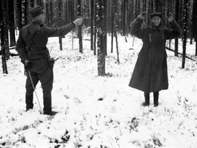 In this 1942 photo, a Soviet agent cracks a wide smile only moments before he is executed as a spy by a Finnish soldier.