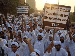 Islamist activists hold signs protesting the release of Asia Bibi, a Pakistani Christian woman who spent eight years on death row for blasphemy, November 21, 2018.