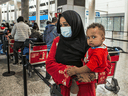 Fatim Ali holds her baby at Toronto's Pearson International airport after arriving from Sudan earlier this year.