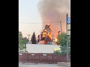 A steeple at St. John Baptiste Parish in Morinville, about 40 kilometres north of Edmonton, crumbles in flames.